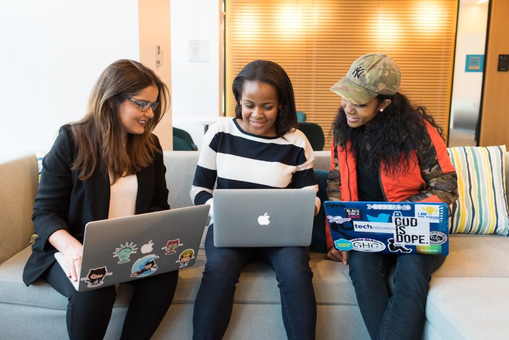 Three women sitting with computers