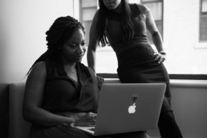 Two women working on a computer