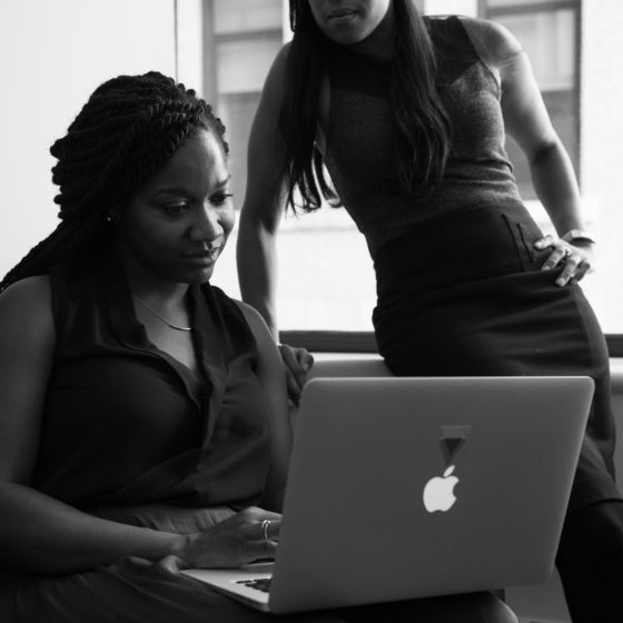 Two women working on a computer