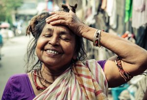 Smiling woman with hand on head - Photo by Loren Joseph on Unsplash