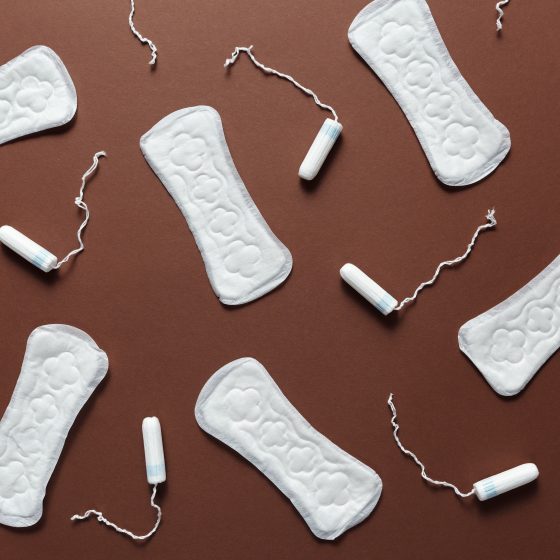 Sanitary Napkins and Tampons on the Brown Background